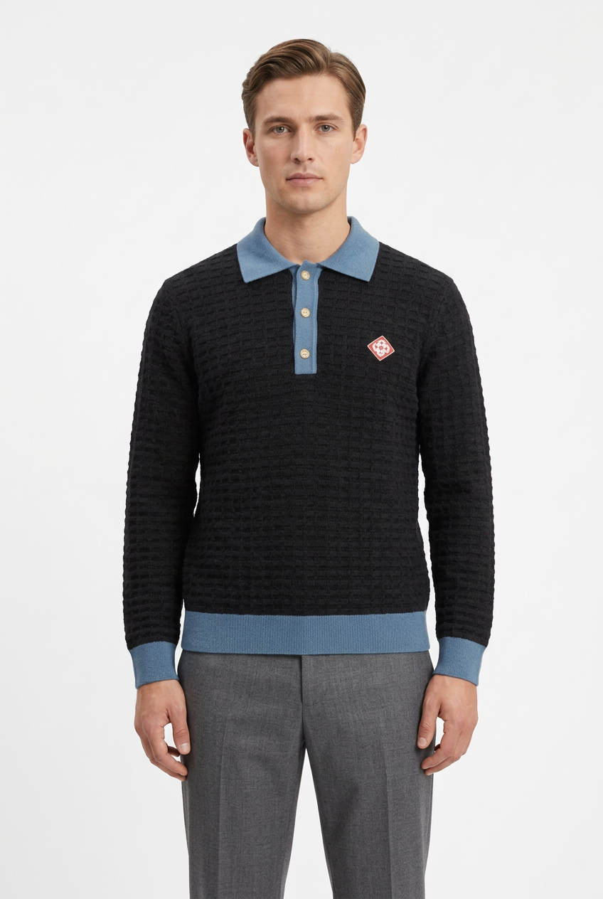 Male model wearing the black and blue knit polo with grey pants