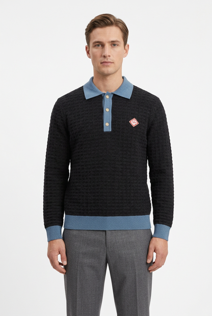 Male model wearing the black and blue knit polo with grey pants